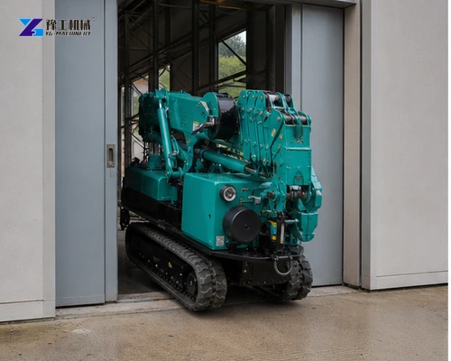 Compact spider crane travelling through restricted industrial doorway