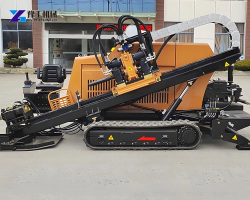 Orange tracked HDD rig showing the drill rack, carriage and stabilizing base