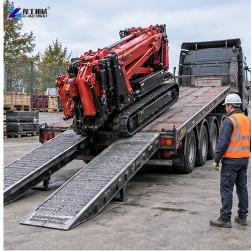 Tracked spider crane being guided up ramps onto a flatbed trailer