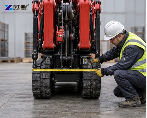 Worker measuring the folded width between tracked spider crane crawler tracks