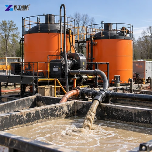Orange drilling fluid tanks, pumps and return pit at an HDD site