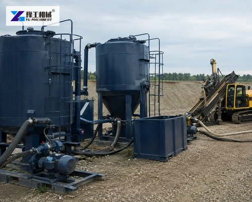 Drilling fluid tanks and pumps beside HDD rig