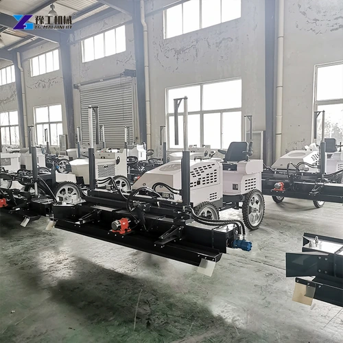 Laser screed machines with wide leveling heads in a workshop