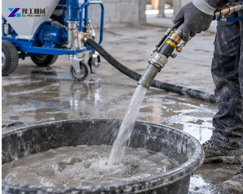 Operator flushing a mortar hose and nozzle after spraying