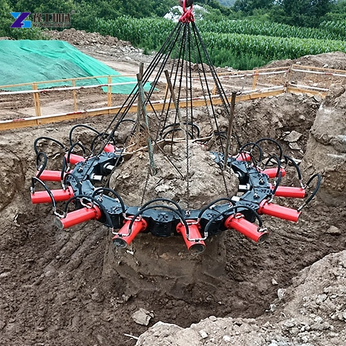 Hydraulic pile breaker suspended around concrete pile on site