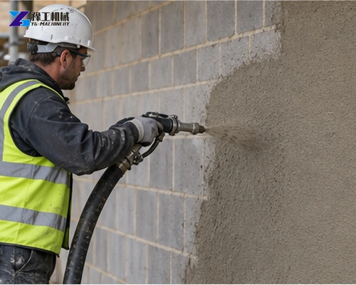 Operator spraying an even render layer onto masonry
