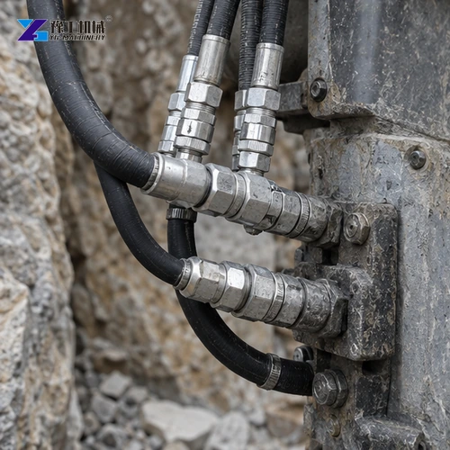 Hydraulic hoses connected to a rock splitter