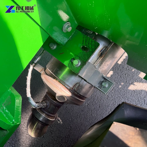 Metal Joint And Bolted Connections Beneath A Green Backhoe Loader Frame