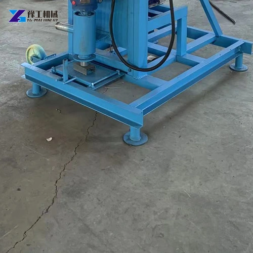 Base frame and small wheels beneath a blue electric well-drilling machine