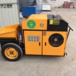 Small Concrete Line Pump Yellow electrically powered concrete pump with hopper, controls and cooling fan