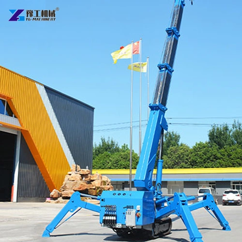 Blue spider crane with extended boom and outriggers in a factory yard