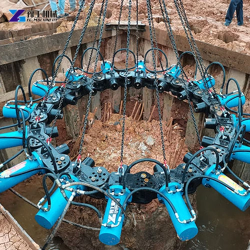 Blue hydraulic pile breaker ring suspended around a concrete pile head