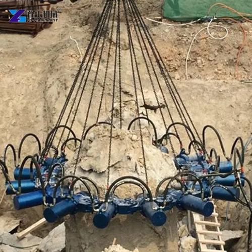 Lifting chains supporting a blue pile breaker at a concrete pile head