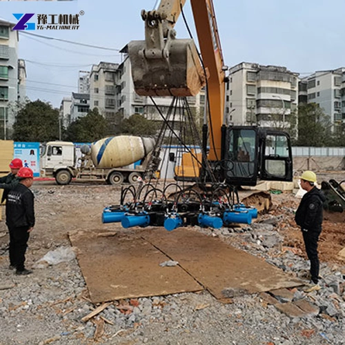 Excavator suspending a hydraulic pile breaker on a building site